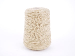 A single cone spool of beige cotton twine or thread, photographed on a seamless white background.